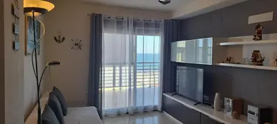 a living room with a large window and a television at Apartamento Chilches Vistas al mar in Chilches