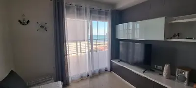 a living room with a large window and a television at Apartamento Chilches Vistas al mar in Chilches