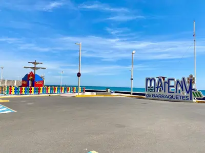 a parking lot next to the ocean with a sign at Mi Oasis Azul Parking, AC, Fibra, VT-54949-V in Sueca