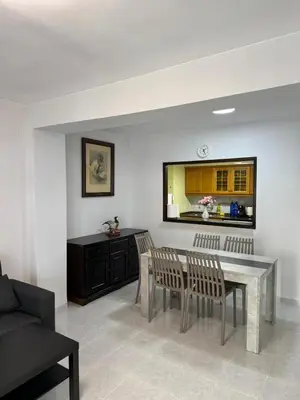 a living room with a dining room table and chairs at precioso apartamento a 10 metros de la playa in Cullera