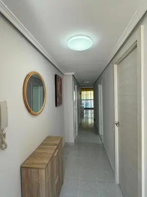 a hallway of a house with a mirror on the wall at precioso apartamento a 10 metros de la playa in Cullera