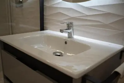 a white sink with a faucet in a bathroom at Hotel Boutique - Estancia dos Olivos in Quesa