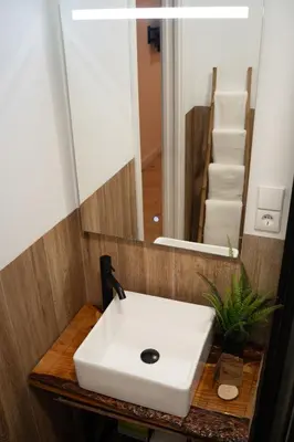 a bathroom with a white sink and a mirror at Hotel Boutique - Estancia dos Olivos in Quesa