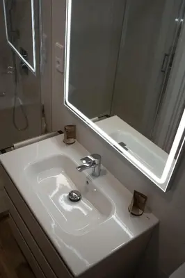 a bathroom with a white sink and a mirror at Hotel Boutique - Estancia dos Olivos in Quesa
