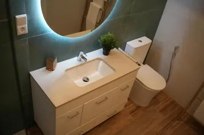 a bathroom with a sink and a mirror and a toilet at Hotel Boutique - Estancia dos Olivos in Quesa