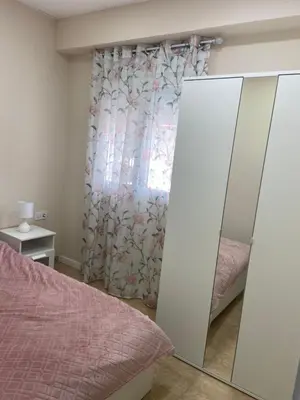 a bedroom with a mirror and a window at Casa Valencia in Valencia