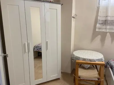 a white closet with a mirror and a stool at Casa Valencia in Valencia