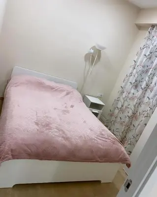 a bedroom with a bed with a pink blanket and a lamp at Casa Valencia in Valencia