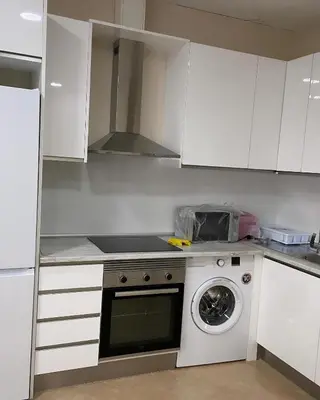 a white kitchen with a washing machine in it at Casa Valencia in Valencia