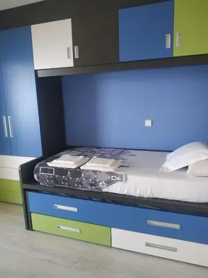 a bedroom with a bed with a blue wall at Desconexión y Relax in Mareny Blau