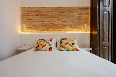 a bedroom with a white bed with two pillows at Espectacular y luminoso apartamento en el centro in Valencia