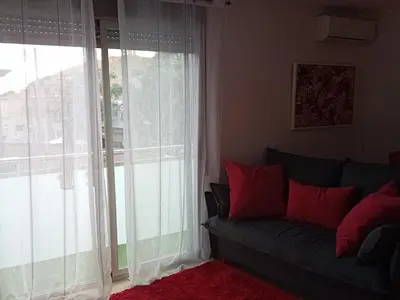 a living room with a couch and a large window at El estudio de las mariposas,sofa cama , cocina y baño in Partida de La Cañada