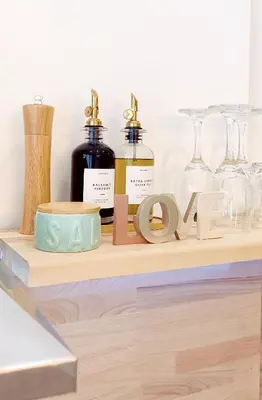 a shelf with wine glasses and ainylinylinylinylinylinylinylinyl table at Loft Céntrico - The Essence by ValeciaGOapartments in Valencia