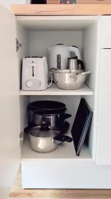 a cabinet filled with various kitchen utensils at Loft Céntrico - The Essence by ValeciaGOapartments in Valencia