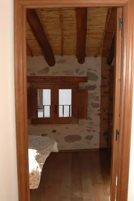 a room with a bed and windows in a house at La Casita de Las Estrellas in Algimia de Almonacid