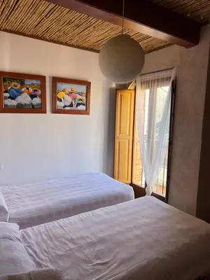 a bedroom with two beds and a window at La Casita de Las Estrellas in Algimia de Almonacid