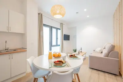 a kitchen and living room with a table with fruit on it at Mediterraneum Suite F in Valencia