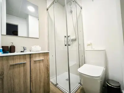 a bathroom with a shower with a toilet and a sink at Mediterraneum Suite F in Valencia