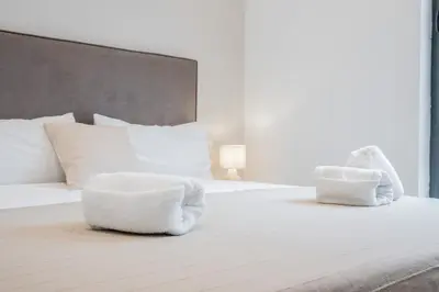 a white bed with two white pillows on it at Mediterraneum Apto E in Valencia