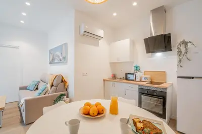 a kitchen with a table with a plate of oranges on it at Mediterraneum Apto E in Valencia