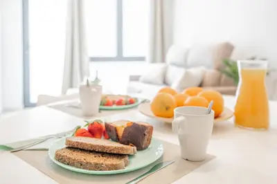 a table with two plates of bread and fruit on it at Mediterraneum Suite D in Valencia
