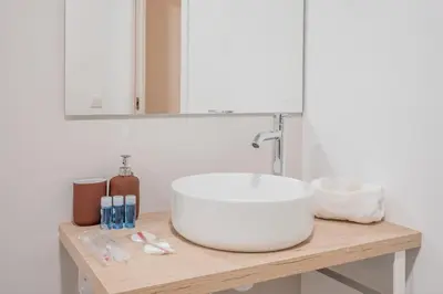 a bathroom with a white sink and a mirror at Mediterraneum Suite D in Valencia