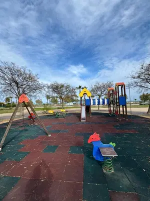 a park with a playground with play equipment at La Costera in Barrio-Mar