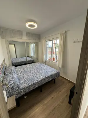 a bedroom with two beds and a large window at La Costera in Barrio-Mar