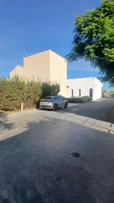 a car parked in a parking lot in front of a building at molino rehabilitado con gran terraza y piscina in Paterna