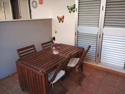 a dining room table with chairs and butterflies on the wall at Apartamento en la playa in Moncófar