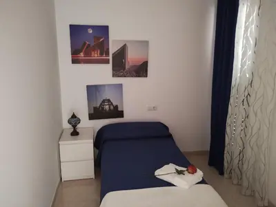 a bedroom with a bed and pictures on the wall at Apartamento en la playa in Moncófar