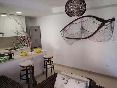 a living room with a net hanging from the wall at Apartamento en la playa in Moncófar
