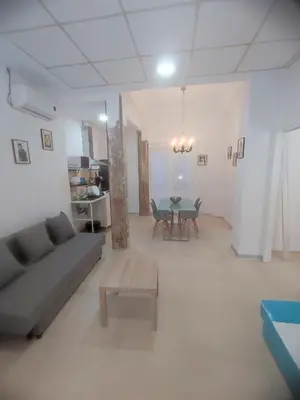 a living room with a couch and a table at Valencia Beach PINK in Valencia
