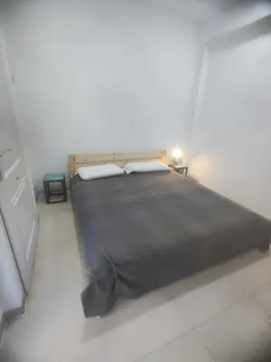 a bedroom with a large bed in a white room at Valencia Beach PINK in Valencia