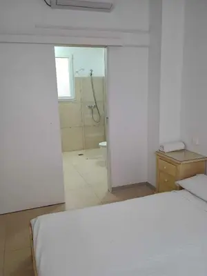 a bedroom with a bed and a bathroom with a shower at Valencia Beach PINK in Valencia