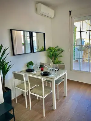 a white dining room table with chairs and wine glasses at Elegant Rooftop by F2 Rental Home in Valencia