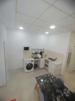 a room with a kitchen with a stove and a table at Valencia Beach RED in Valencia