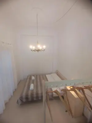 a room with a table and a bench and a chandelier at Valencia Beach RED in Valencia