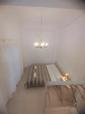 a room with a bed and a chandelier at Valencia Beach RED in Valencia