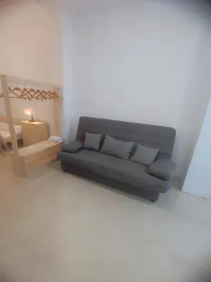 a living room with a gray couch and a table at Valencia Beach RED in Valencia