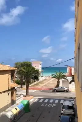 a view of a street with a beach and a car at Apto 3 habitaciones, vistas al mar Moncofar Grao in Moncófar