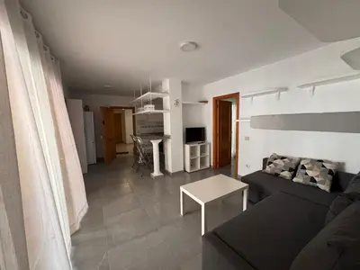 a living room with a couch and a table at Apto 3 habitaciones, vistas al mar Moncofar Grao in Moncófar