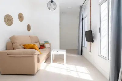 a living room with a couch and a tv at Apartamento Ruzafa 1 habitacion y 2 sofas cama in Valencia