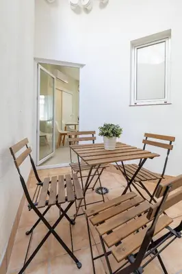a wooden table and chairs in a room at Apartamento Ruzafa 1 habitacion y 2 sofas cama in Valencia