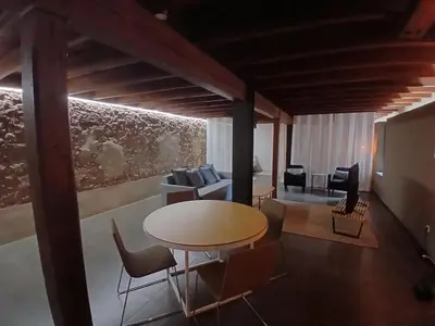 a living room with a table and a couch at Apartamento en molino con piscina in Paterna