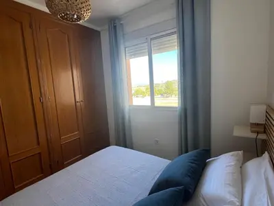 a bedroom with two beds and a table with a lamp at Alojamiento Rural Ikigai in Losa del Obispo