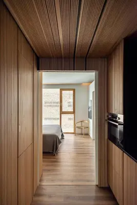 a bedroom with a bed in a room with wooden walls at Apartamentos Maestro Sosa in Valencia