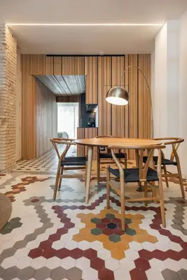 a dining room with a wooden table and chairs at Apartamentos Maestro Sosa in Valencia