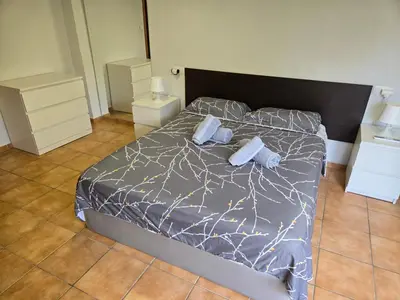 a bedroom with a bed with two pillows on it at Chalet con piscina LUA HOME in Manises
