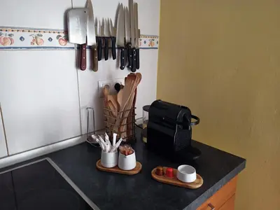 a kitchen counter with cups and utensils on it at Chalet con piscina LUA HOME in Manises